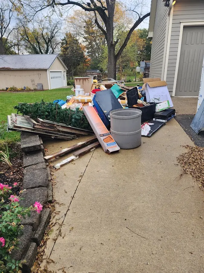 Dumpster being loaded with debris for 30 Yard Dumpster Rental in Green Cove Springs